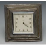 An Art Deco silver easel clock, with white enamelled dial with Arabic numerals,