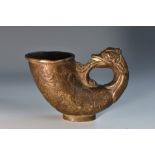 A Chinese dark patinated bronze libation vessel, cast in the Archaic taste with a mythical beast,