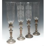 A set of four 19th century silver plate on copper table candle lanterns, star-pierced sconces,