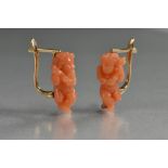 A pair of carved coral cherub and wreath earrings, hinged unmarked yellow metal fittings, 17mm high,