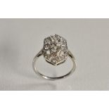 An Art Deco style panel ring, shield crest inset with ten round cut diamonds,