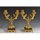 A pair of Baroque design gilt metal and marble two-light mantel candelabra,