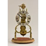 A Victorian brass skeleton clock, 16cm silvered chapter ring inscribed with Roman numerals,