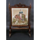 A Victorian rosewood firescreen, fretwork leafy scroll cresting,