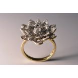 A diamond encrusted flower head cluster ring,