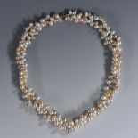 A cultured pearl three colour intertwined cluster necklace, with egg shaped beads, 9ct gold clasp,