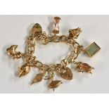 A 9ct gold curb link charm bracelet, suspending eight charms including Tankards, Lantern, duck etc,
