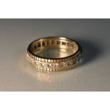 A 9ct yellow and white gold eternity ring, central raised band of white stone accents,