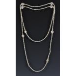 A long single strand of cultured pearl necklace, divided by ten cultured pearl discs,