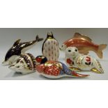 Ceramics - a Royal Crown Derby carp paperweight; a hedgehog paperweight; a dolphin paperweight;