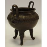 A 19th century Chinese bronze tripod censer, cast with a band of lotus,