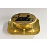 A 19th century gilt bronze and 'niello' table vesta, hinged cover decorated with a comical figure,