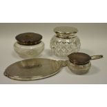 Three silver topped dressing table jars;