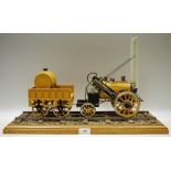 A stationary model Stephenson's Rocket locomotive and tender, track base,