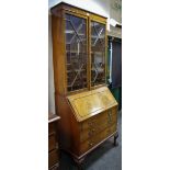 An early 20th century bureau bookcase, two astragal glazed doors enclosing shelving,