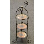 A wrought iron and copper three tier cake stand