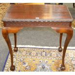 A mahogany silver table carved border and frieze, cabriole legs, ball and claw feet.