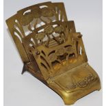 An Art Nouveau brass combination letter rack and inkwell
