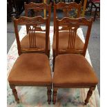 A set of four Edwardian mahogany dining chairs, shaped top rail, pierced splat, stuffed overseat,