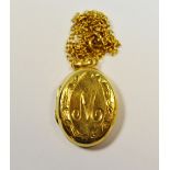 A 9ct gold locket engraved with the letter M on a 9ct gold chain 6g gross