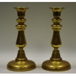A pair of 19th century brass ejector candlesticks, bell shaped nozzles, baluster columns,