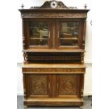 A French oak sideboard, spindled pediment, two glazed doors to top, two drawers over,
