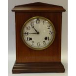 An Edwardian mahogany mantel clock New Haven USA, Architectural pediment, painted dial,