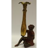 An early 20th century Blackamoor type cold painted figural spill vase in the form of a monkey