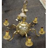 A six branch brass chandelier pierced globular body scrolling S shaped branches