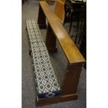 An oak prayer bench with St Giles Matlock kneeler pad.