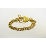 A 9ct gold diamond cut curb link bracelet of thick gauge; 9ct heart shaped locket 30.