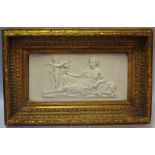 A late 19th century reconstituted marble rectangular wall plaque decorated in relief with classical