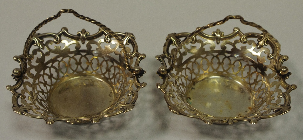 A pair of 19th century white metal sweet meat baskets, pierced throughout, shell and scroll border.