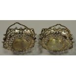 A pair of 19th century white metal sweet meat baskets, pierced throughout, shell and scroll border.
