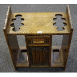An early 20th Century oak stick stand nulled front short drawer over linen fold panel