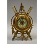 A late 19th century gilt and silvered metal easel timepiece