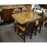 An oak drawer leaf table; four chairs;