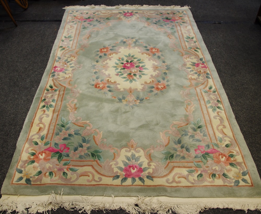 A 20th Century Chinese rug in tones of subtle greens,