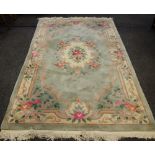 A 20th Century Chinese rug in tones of subtle greens,