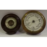 Barometers - a late 19th century/early 20th century oak cased aneroid barometer;