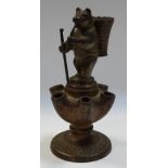 A 19th century cast iron novelty pipe stand/vesta, as a bear, he stands,