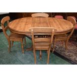 A pine extending dining table and four chairs