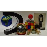 An unusual globe night light, the world suspended by a magnet, black stand,