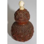 A 19th century carved cocquilla nut of gourd form,