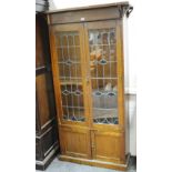 An Arts and Crafts bookcase two lead glazed doors,