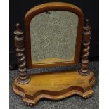 A Victorian mahogany dressing mirror arched glass, turned finials, barley twist uprights,