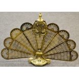 A pierced brass peacock fan folding firescreen.