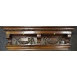 A 19th century oak overmantel shelf profusely carved holding two drawers above carved brackets and