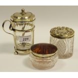 A tortoise shell and silver topped jar; another silver topped jar;