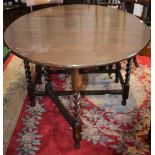 An early 20th century oak gateleg table, spirally turned legs,